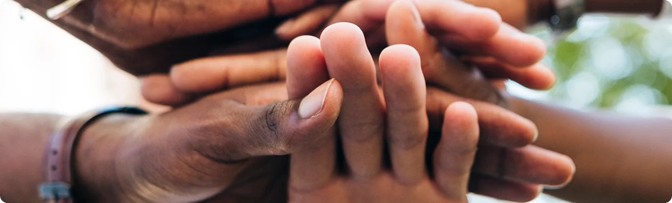 Hands joined together representing community impact
